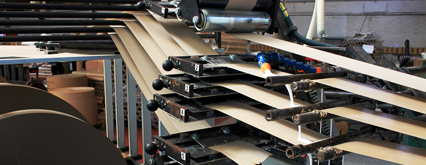 Cardboard tubes in the process of being made in a factory