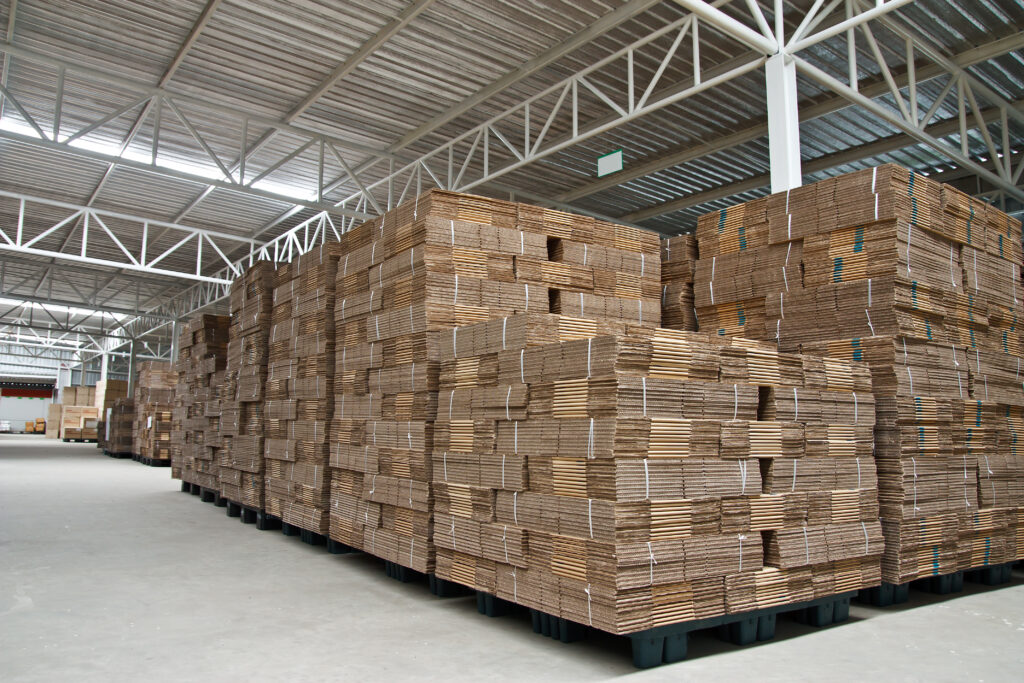 Stacks of cardboard flat packs in a warehouse